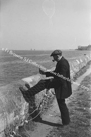 FISHERMAN MENDING NETS